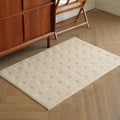 Thảm dệt Dash Rug màu trắng kem tối giản trên sàn gỗ